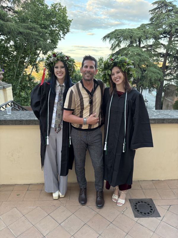 owner and his daughters at their graduation
