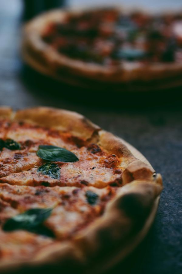 2 pizzas on a table pizza