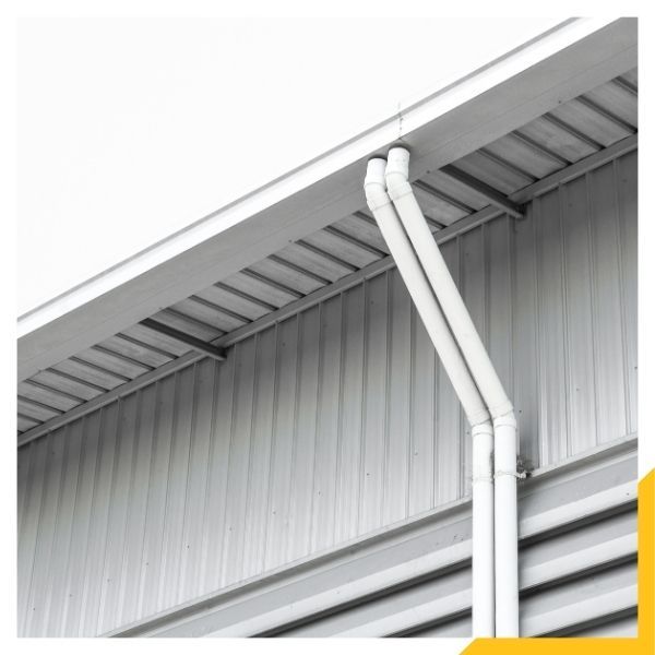downspouts connected to a gutter on a commercial building