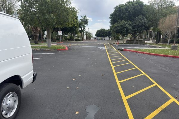 A redone yellow walkway in a parking lot