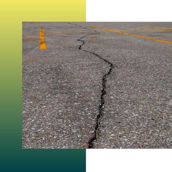 A large crack in the parking lot's asphalt 