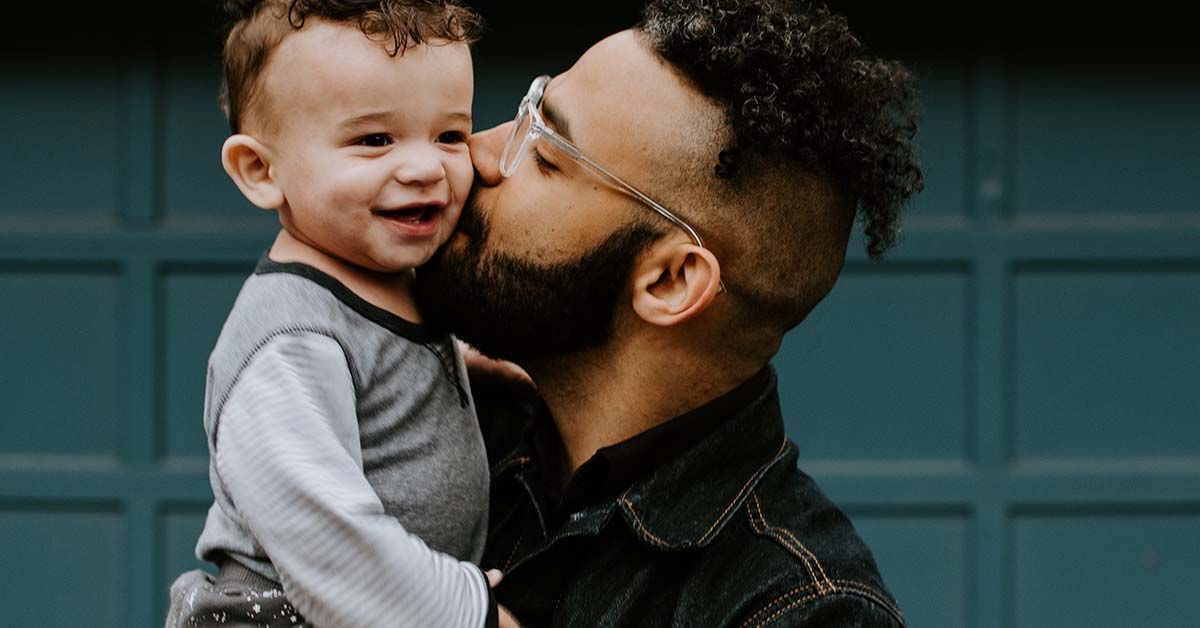 man holding child close to chest