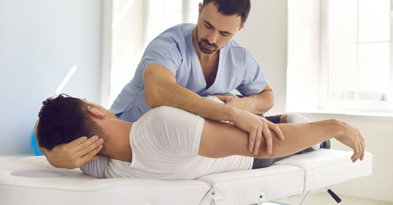 chiropractor with patient