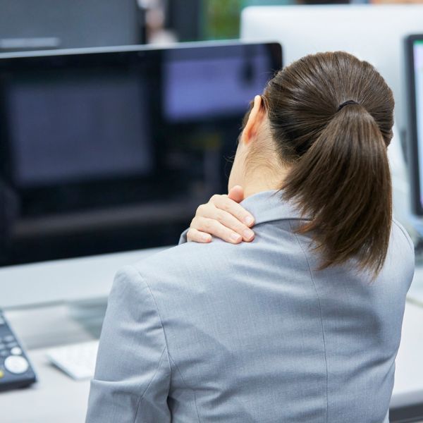 a woman holding her neck in pain When to Seek Chiropractic Care for Neck Pain.jpg