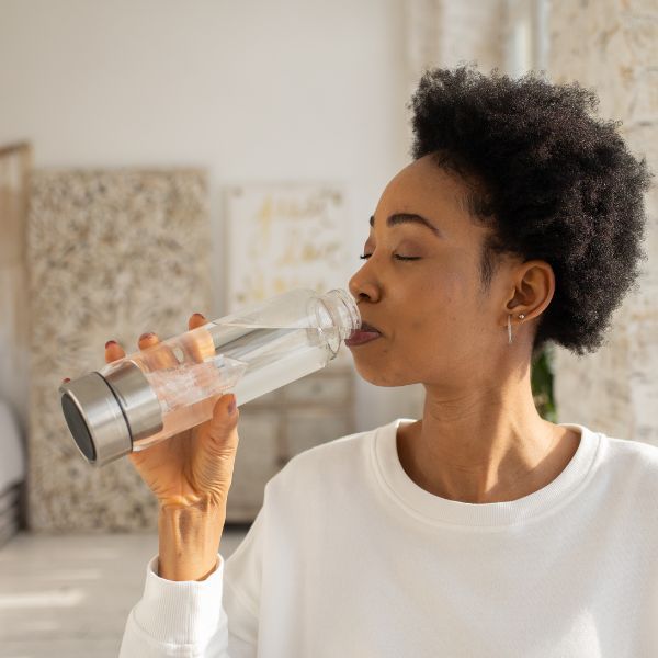 a woman drinking water How To Get The Most Out of Chiropractic Adjustments.jpg