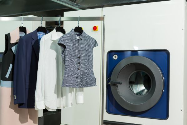 Various clothing items hanging on a rack. 