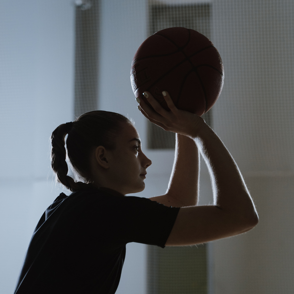woman shooting a basketball 