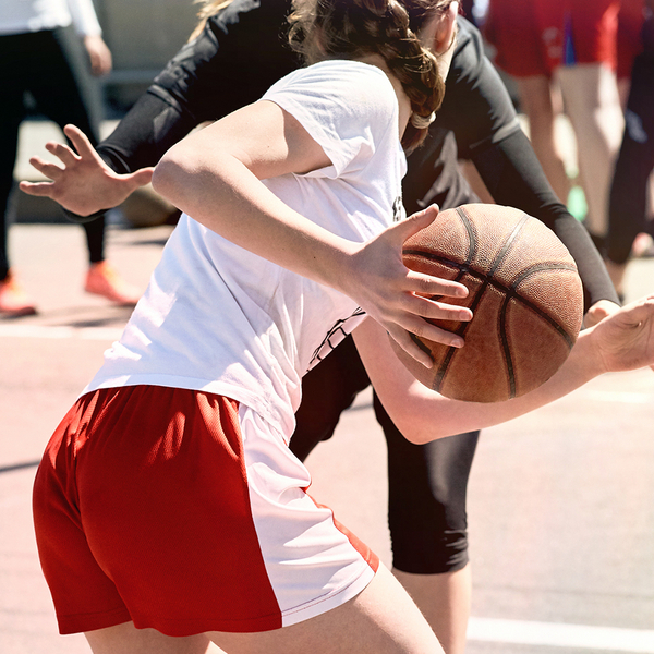 girl playing with basketball