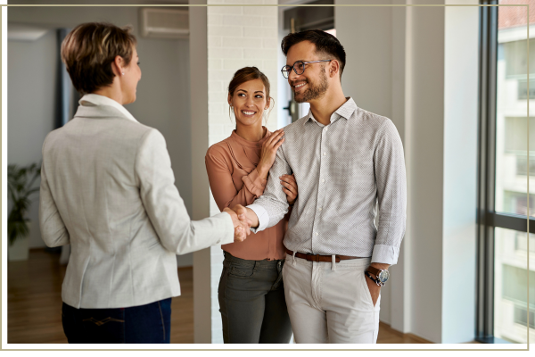 realtor shaking hands with clients