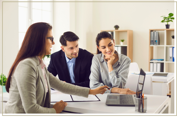 realtor showing clients listings on computer