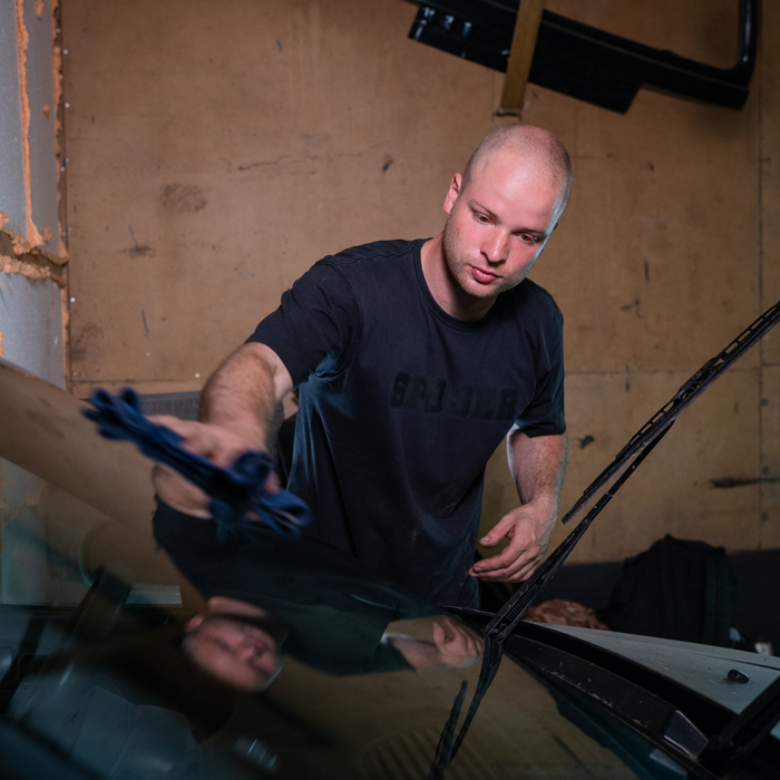 man wiping windshield