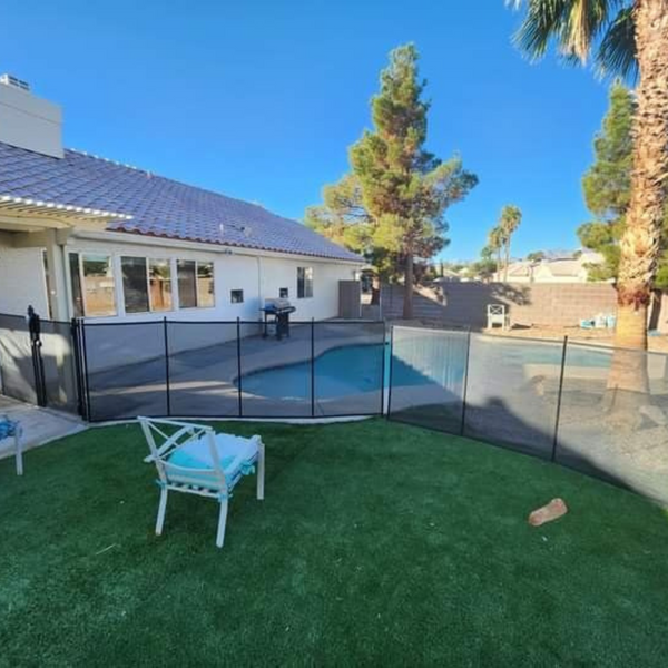 A fence around a custom pool