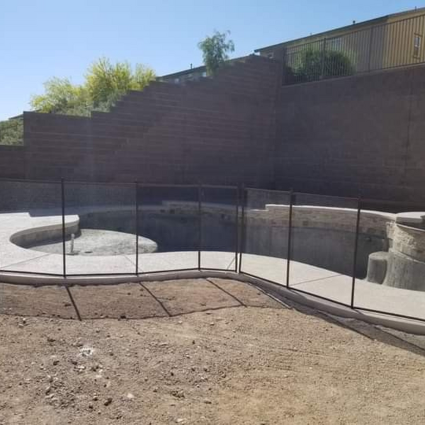 A custom fence being added to a pool that is being installed