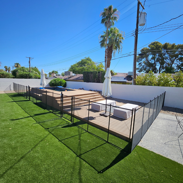 A temporary fence around a hot tub and deck