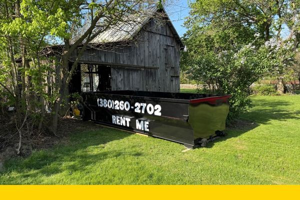 roll off dumpster rental in front of a barn