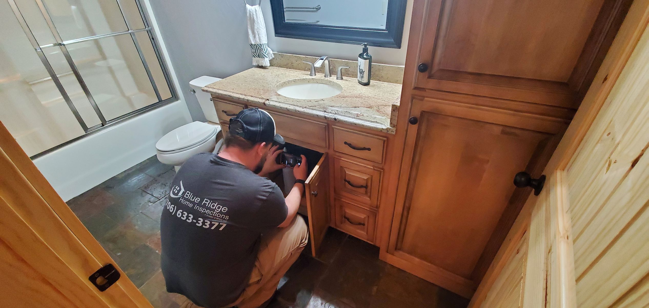 Levi inspecting plumbing under the bathroom sink.jpg