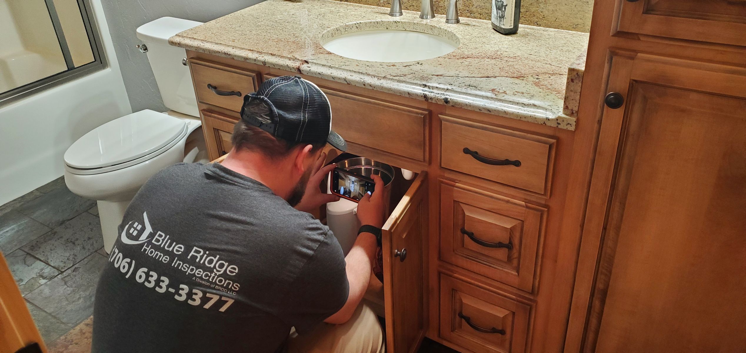 Levi inspecting plumbing under the bathroom sink 2.jpg