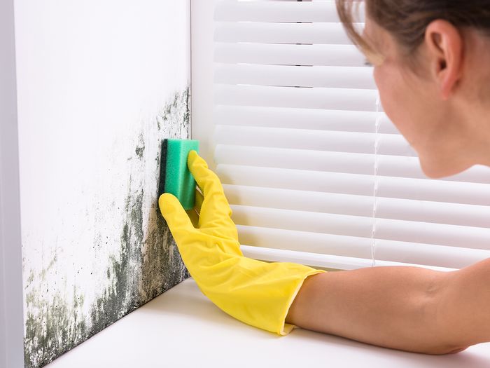 woman wiping mold