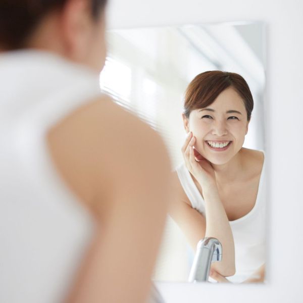 woman smiling in mirror woman smiling in mirror