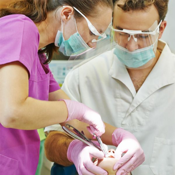 dentists working in patient's mouth