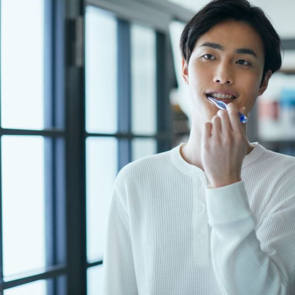 A person brushing his teeth.