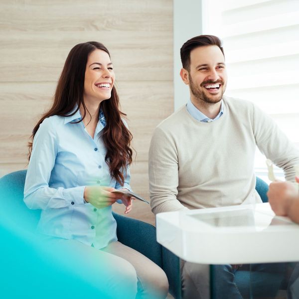 couple talking with dentist