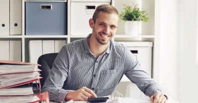 image of a smiling man at a desk