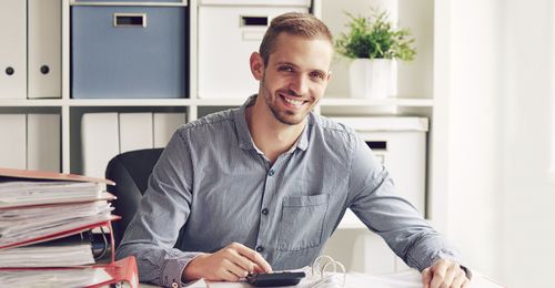image of a smiling man at a desk