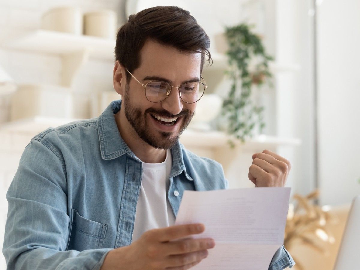smiling man looking at paperwork