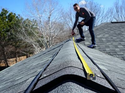 roofer measuring a roof
