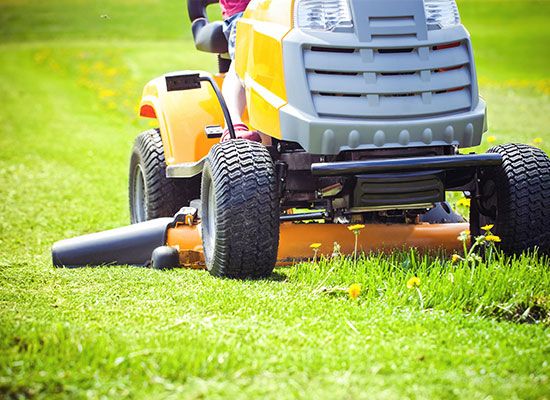 Man mowing grass on riding lawn mower