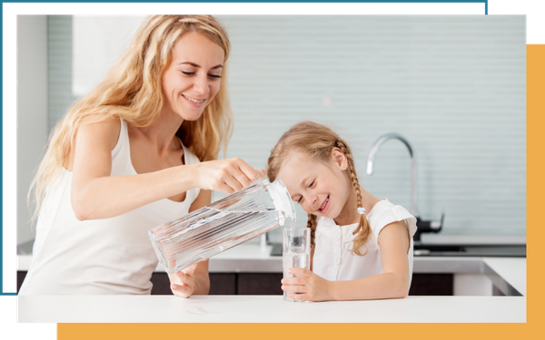 Mother serving daughter water