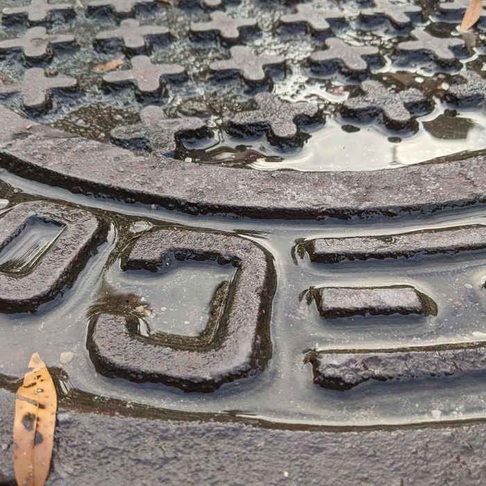 close up of a metal manhole cover close up of a metal manhole cover