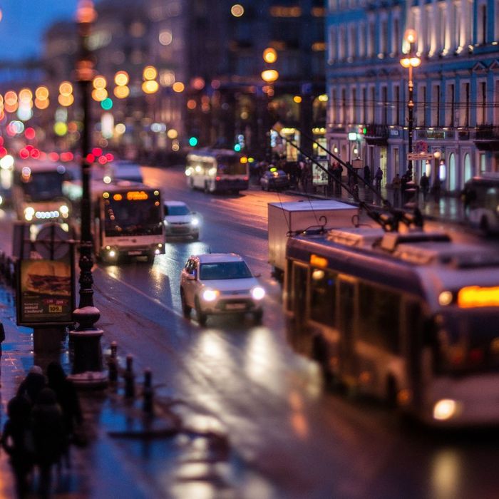 car and buses in a city at night