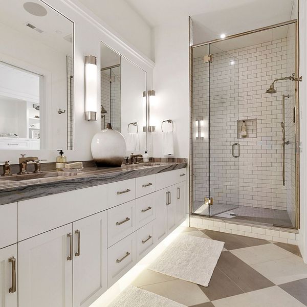 white bathroom with gold accents and large floor tiles