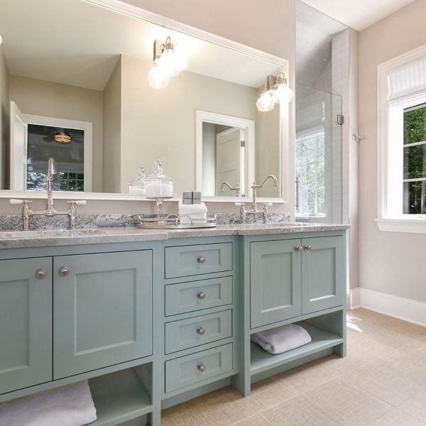 renovated bathroom with light blue cabinets