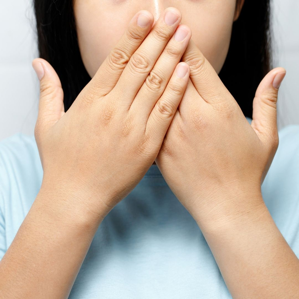 woman covering mouth