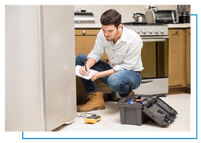 HVAC technician taking notes on a clipboard next to a refrigerator. 