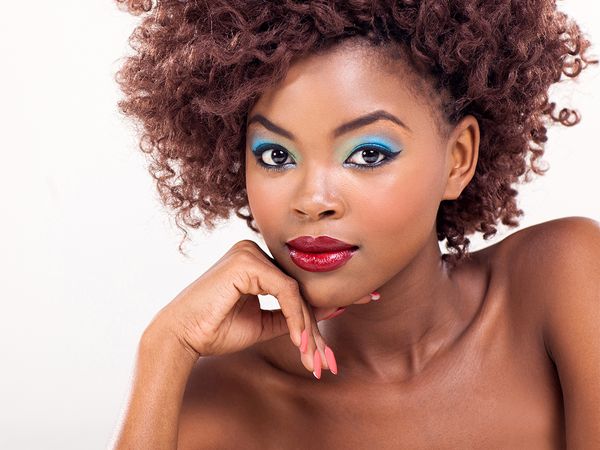 Image of an African American woman with beautiful makeup on her face. 