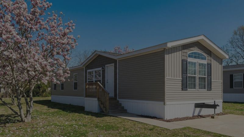 manufactured home sits under a clear blue sky