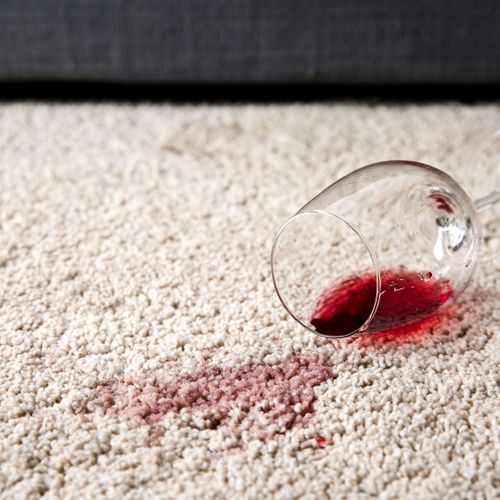 red wine stain on a white carpet