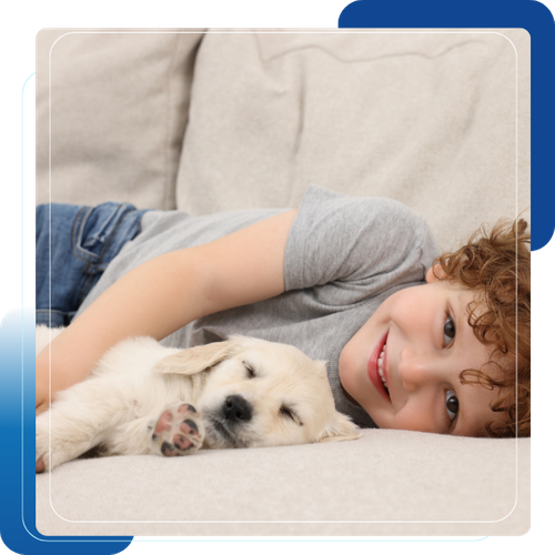 kid and puppy on white couch 