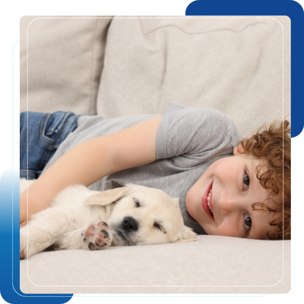 kid and puppy on white couch 