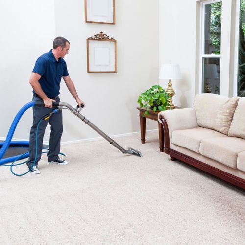 man cleaning a white carpet