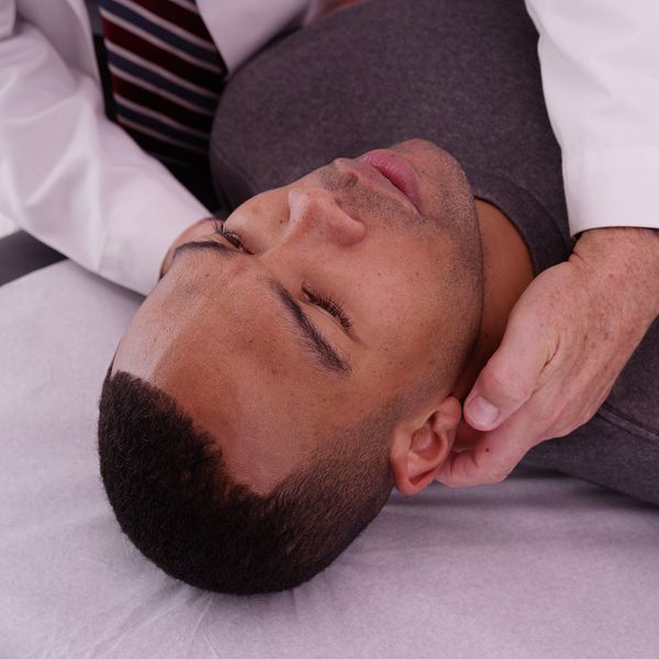 Man visiting doctor for neck pain