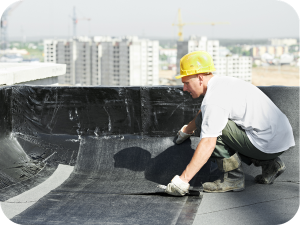 Roofing contractor installing pieces of a flat roof. 2 roofing waterproofing.png