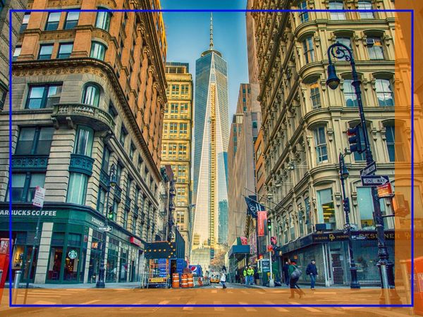A street view in Manhattan looking towards One World Trade Center, surrounded by classic and modern buildings. A street view in Manhattan looking towards One World Trade Center, surrounded by classic and modern buildings.