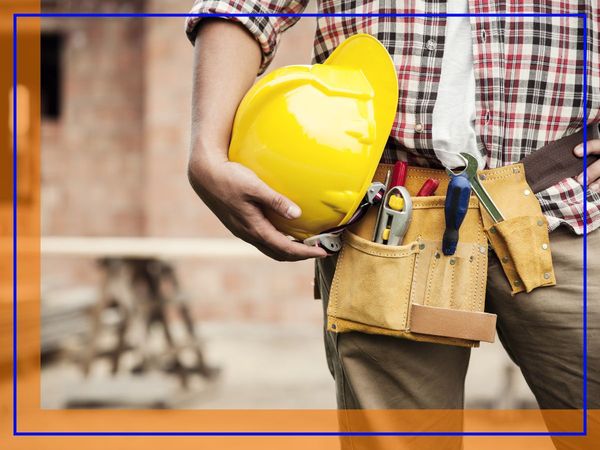 Masonry contractor holds hard hat Masonry contractor holds hard hat