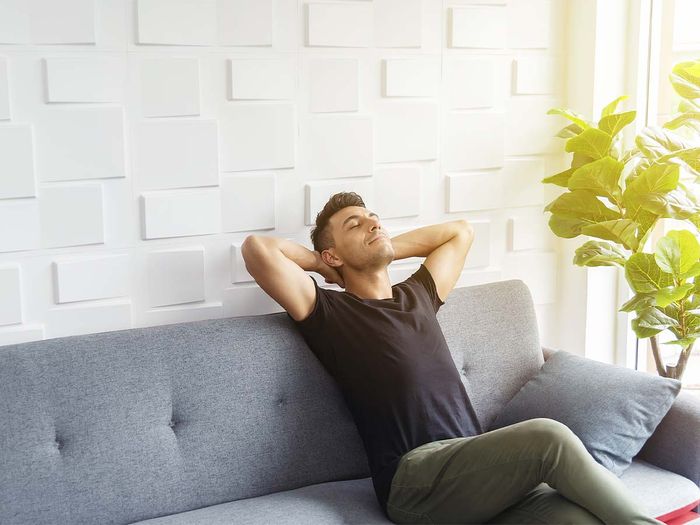 A man taking a deep breath and relaxing