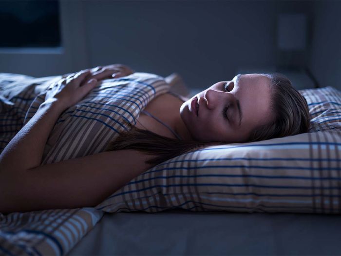 A woman sleeping in her bed